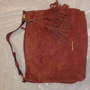 Michael Kors pink suede hobo style bag with tassels.